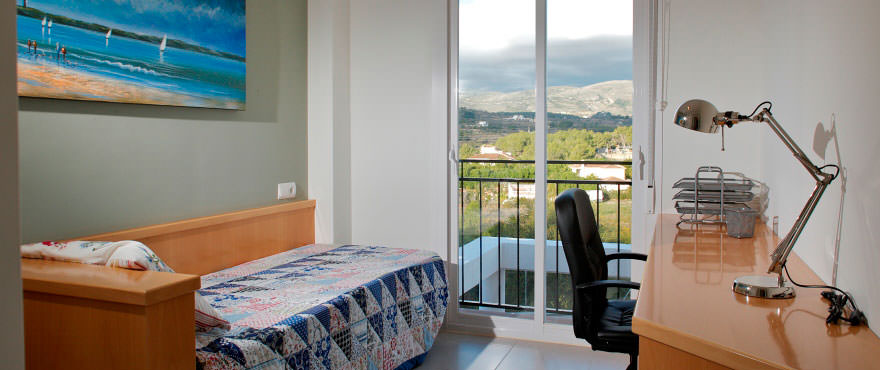 Single bedroom with desk and window in homes for sale in Calpe