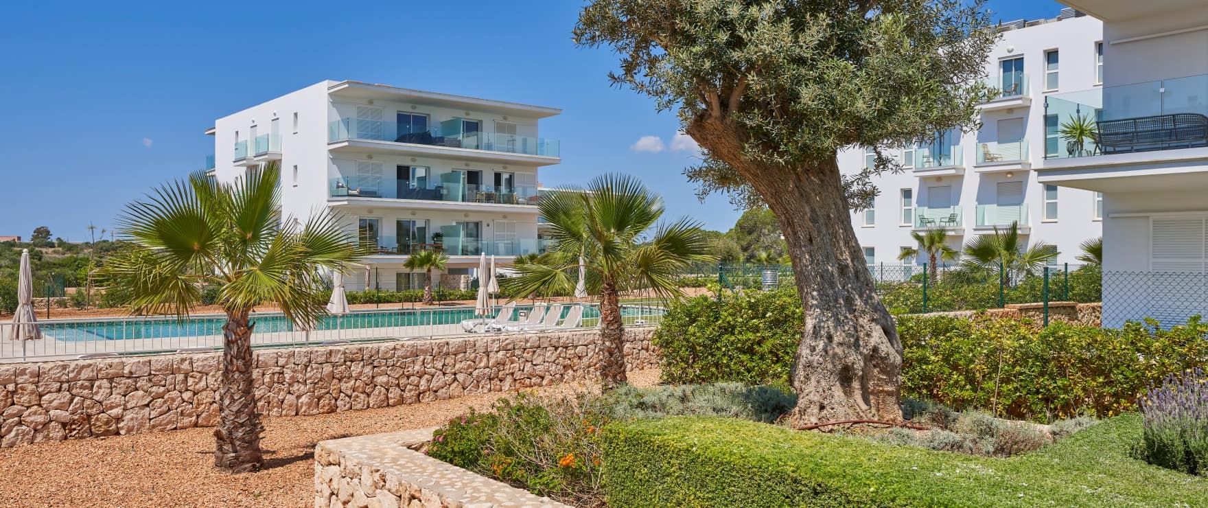 Compass, communal pool and gardens, next to the marina in Cala d´Or
