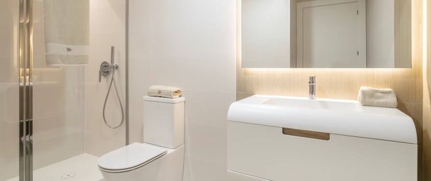 Fully equipped modern bathroom at Iconic, with shower screens installed