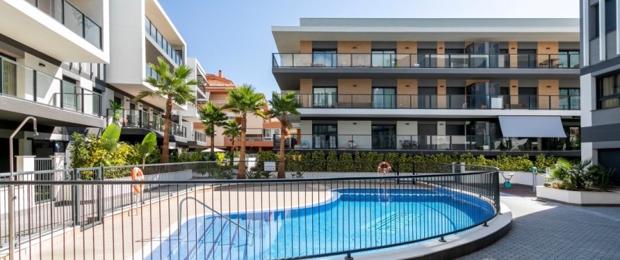 Modern apartments for sale in Jávea, with communal pools and gardens.